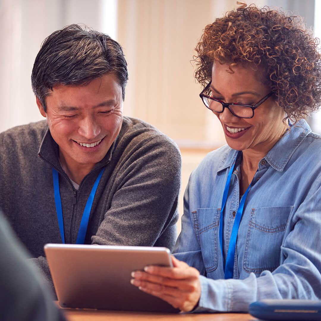 two teachers viewing a tablet