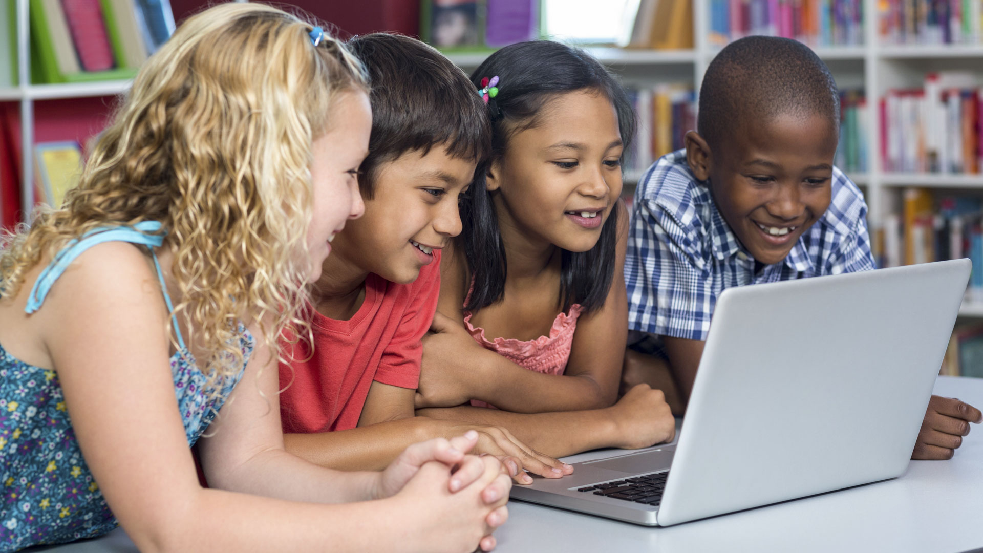 classmates looking at laptop