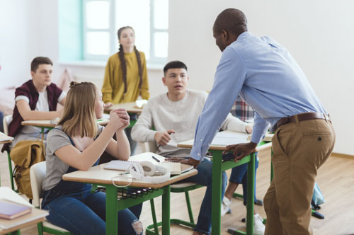 teacher and high school teenage students in classroom